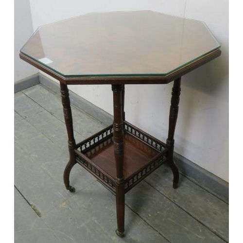 754 - An Edwardian mahogany octagonal two-tier occasional table, featuring arcaded gallery, on outswept oc... 