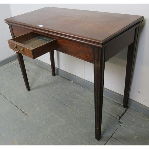 755 - A Georgian mahogany turnover tea table, strung with satinwood, the central drawer with brass swan-ne... 