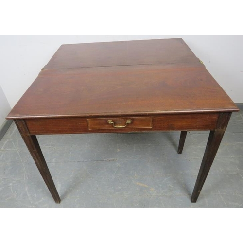 755 - A Georgian mahogany turnover tea table, strung with satinwood, the central drawer with brass swan-ne... 