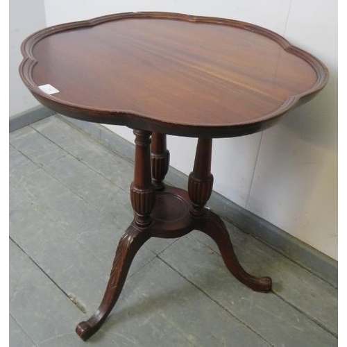 760 - An Edwardian mahogany Regency Revival occasional table, with shaped edge, over fluted cluster column... 