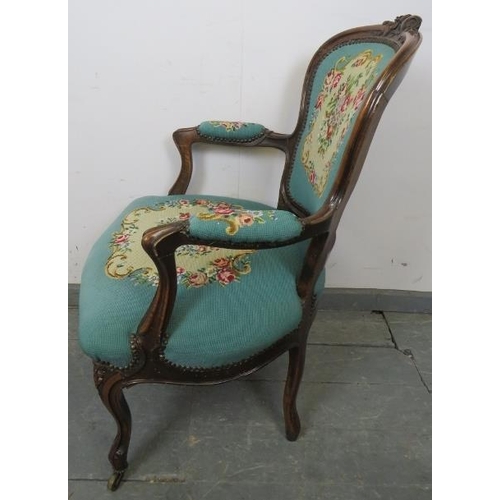 763 - A 19th century walnut show-wood open-sided armchair, upholstered in handmade cross stitch material b... 