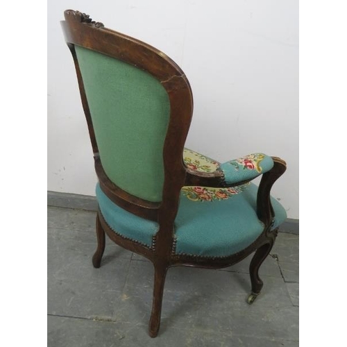 763 - A 19th century walnut show-wood open-sided armchair, upholstered in handmade cross stitch material b... 