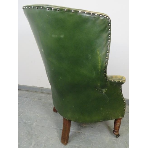 764 - An Edwardian Georgian Revival barrel back armchair, upholstered in distressed green leather with bra... 