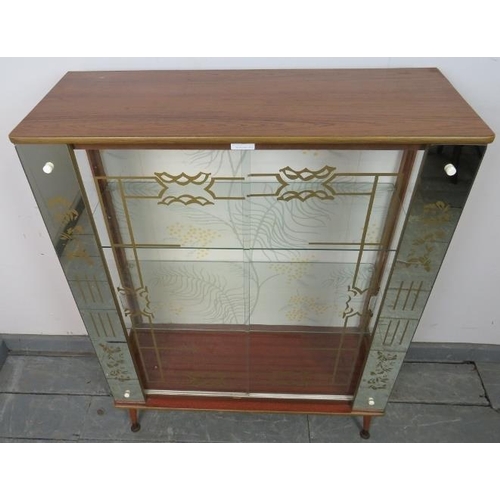 771 - A 1950s mirrored glazed display cabinet, housing two loose glass shelves, on dansette legs. 
Conditi... 