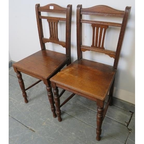 777 - A pair of Edwardian hall chairs with pierced back splats, on tapering turned supports with side stre... 