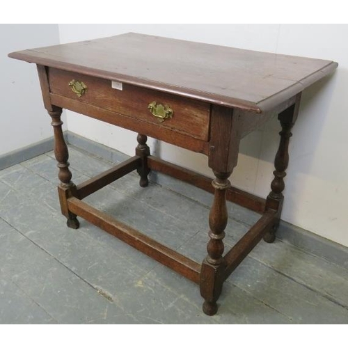 778 - An 18th century oak side table, the single drawer with brass batwing handles, on baluster turned and... 