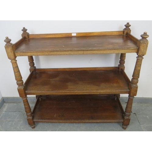 781 - A late Victorian oak three-tier buffet with ¾ galleries, turned finials 
and tapering turned upright... 