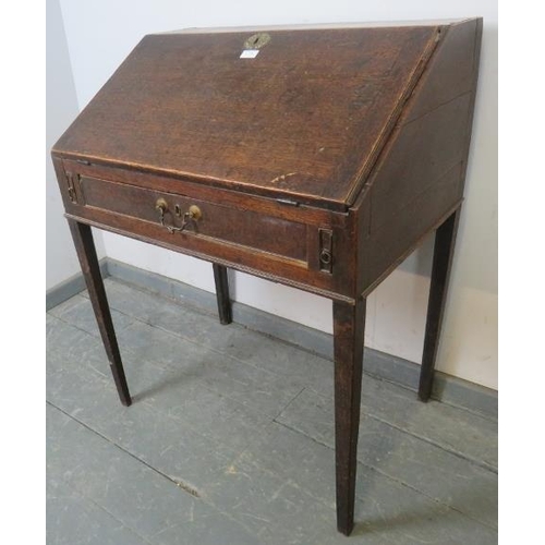 790 - An 18th century oak clerk’s desk, the fall front opening onto a fitted interior, above one long cock... 