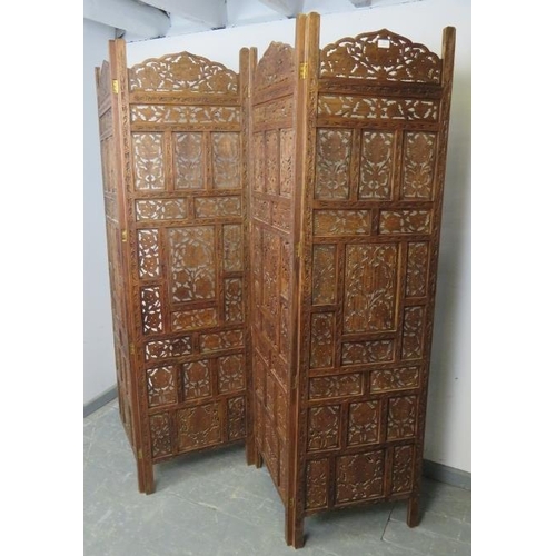 801 - A vintage hardwood Eastern carved and pierced four-section folding screen. 
Condition report: One fo... 