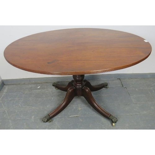 803 - A Regency Cuban mahogany oval tilt-top breakfast table, with reeded edge, on a turned column with fo... 