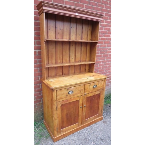 808 - An antique pine kitchen dresser, with plate rack shelving over a sideboard base housing two short dr... 