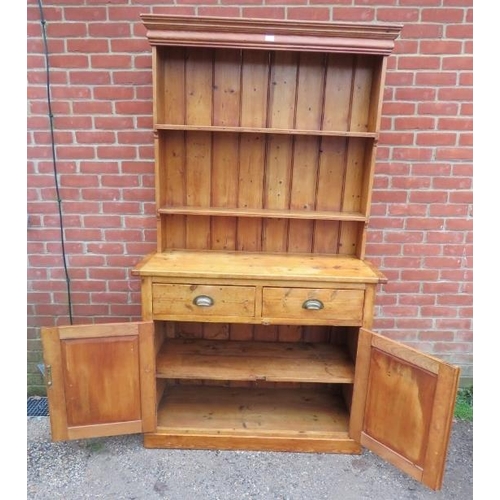 808 - An antique pine kitchen dresser, with plate rack shelving over a sideboard base housing two short dr... 