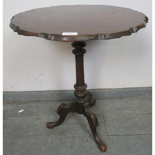 812 - A Georgian and later mahogany piecrust occasional table, on a turned column with scrolled tripod sup... 