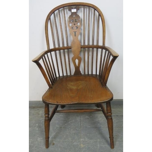 814 - A 19th century oak and elm Windsor wheelback chair, on turned canted supports with an ‘H’ stretcher.... 