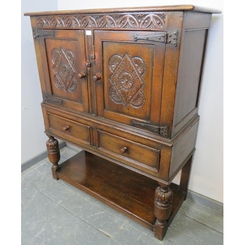 829 - A vintage oak court cupboard of small proportions in the 16th century taste, with carved frieze abov... 