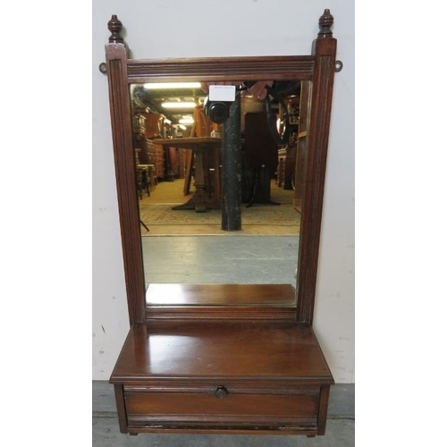 836 - An Edwardian mahogany wall mirror with reeded detail and turned finials, above a box base with fall ... 