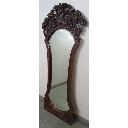 844 - A Victorian mahogany dressing mirror, the very ornate carved and pierced surround depicting entwined... 