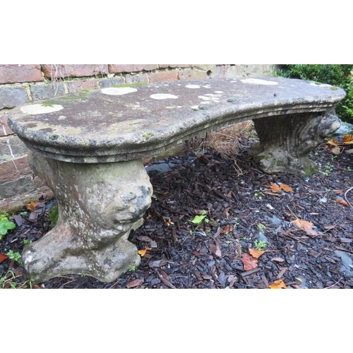 895 - A nicely weathered reconstituted stone curved garden seat, on end supports in the form of lions.
Con... 