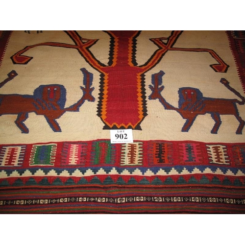 902 - A South West Persian Qashqai Kilim carpet depicting stylised animals beneath a tree. In very good co... 