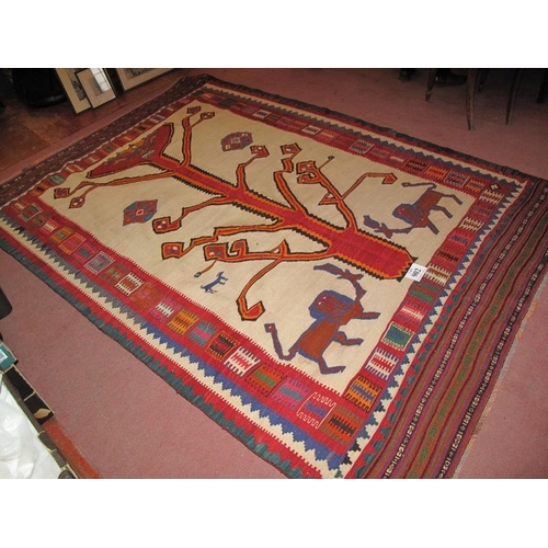 902 - A South West Persian Qashqai Kilim carpet depicting stylised animals beneath a tree. In very good co... 