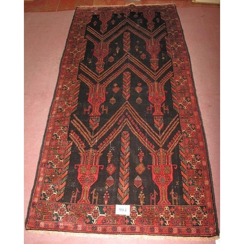 904 - North East Persian Meshed Belouch rug. Repeat pattern depicting urns on a deep charcoal field. Very ... 