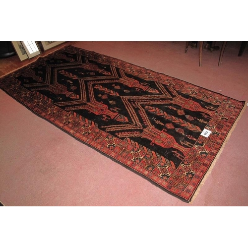 904 - North East Persian Meshed Belouch rug. Repeat pattern depicting urns on a deep charcoal field. Very ... 