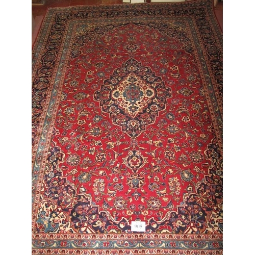 905 - A central Persian Kashan carpet central motif. Heavy foliage on claret ground and wide blue borders ... 