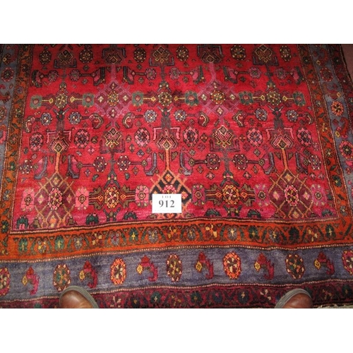 912 - North West Persian Bidjar carpet, heavy pattern on claret ground. Very thick weave and in good condi... 