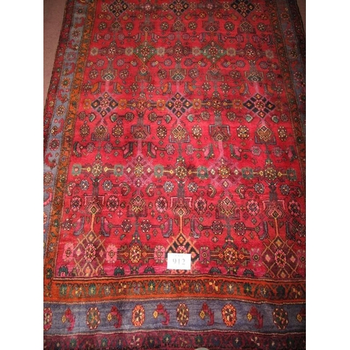 912 - North West Persian Bidjar carpet, heavy pattern on claret ground. Very thick weave and in good condi... 