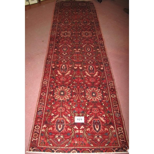 919 - A fine Persian Heriz runner, central repeat pattern on claret field. Good condition, slight colour v... 