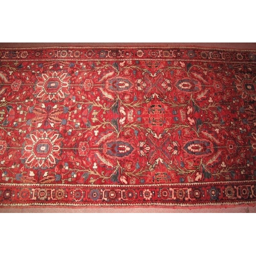 919 - A fine Persian Heriz runner, central repeat pattern on claret field. Good condition, slight colour v... 