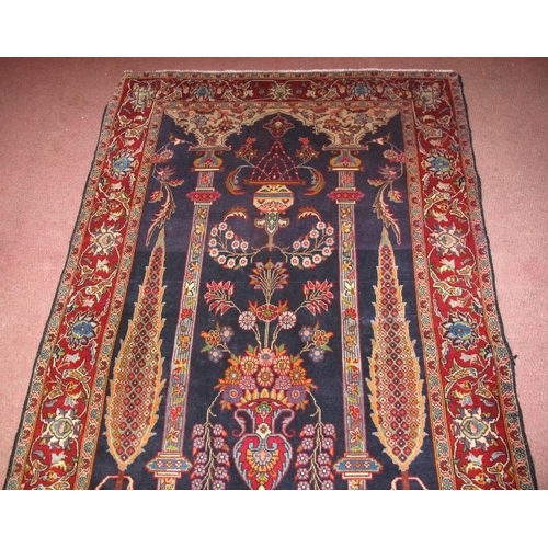 920 - Persian Qom rug, central scene of columns and vase with flowers. 157cm x 105cm.