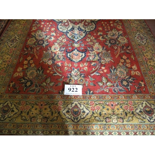 922 - A Persian Isfahan rug, central pattern on soft red field and mustard border. Good condition. 215cm x... 