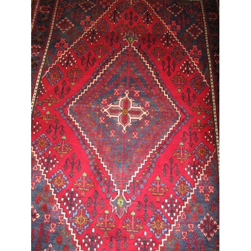 925 - A Persian Meimeh rug diamond motif on blue/red field in very clean condition. 200cm x 134cm.