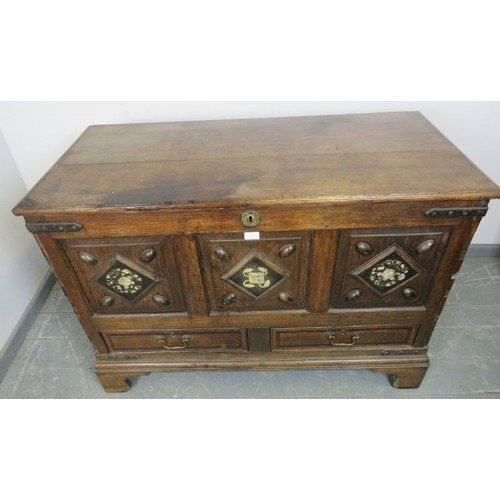 882 - An 18th century and later oak mule chest, the fielded front panels inlaid with mother of pearl and b... 