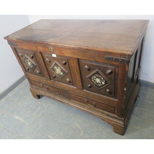 882 - An 18th century and later oak mule chest, the fielded front panels inlaid with mother of pearl and b... 