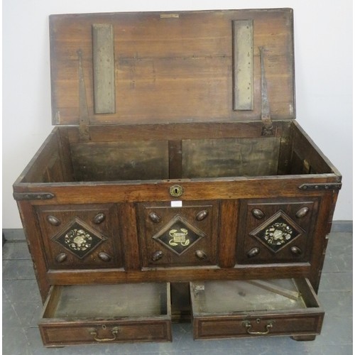 882 - An 18th century and later oak mule chest, the fielded front panels inlaid with mother of pearl and b... 