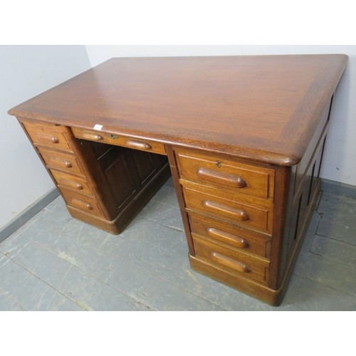 888 - An Art Deco medium oak kneehole desk, with fielded panels, housing an array of eight drawers and two... 