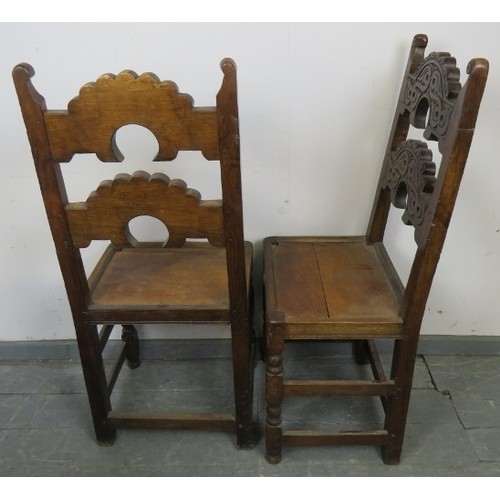 773 - A pair of 19th century oak Derbyshire chairs, with scrolled finials, the shaped backrests with relie... 