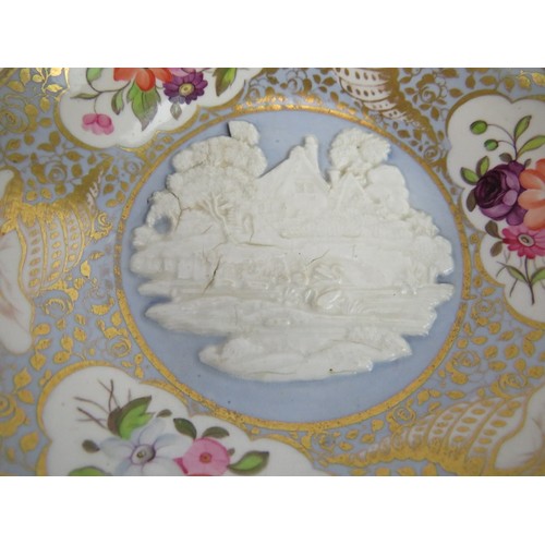 10 - An early 19th century porcelain trio of saucer, tea and coffee cups, each with cottage scene relief ... 