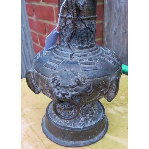 50 - An antique Chinese bronze vase in the Archaic style decorated with dragons and with lion mask handle... 