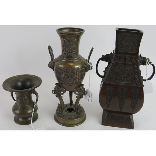 90 - Two Chinese bronze censers, one with cover, a bronze temple bell and two bronze vases, one on carved... 