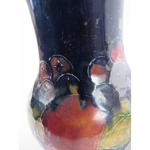 104 - William Moorcroft tall vase in pomegranate design with signed and incised marks to base, circa 1930'... 