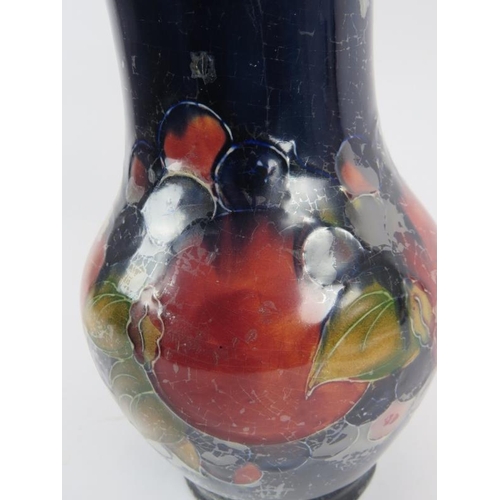 104 - William Moorcroft tall vase in pomegranate design with signed and incised marks to base, circa 1930'... 