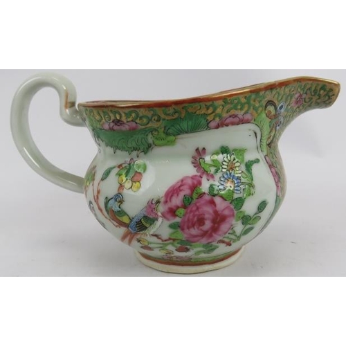 106 - A 19th century Chinese Famille-rose porcelain jug, painted in enamels and gilt with opposing figurat... 