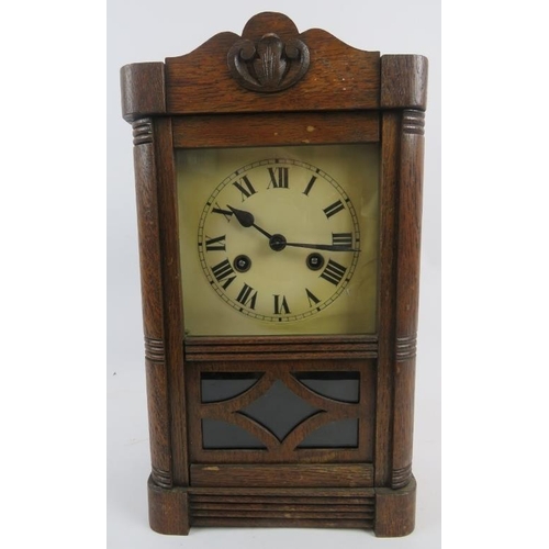 131 - An early 20th century oak cased striking mantel clock with pendulum and key. Height 38cm. 
Condition... 