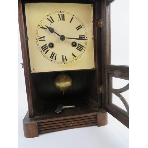 131 - An early 20th century oak cased striking mantel clock with pendulum and key. Height 38cm. 
Condition... 