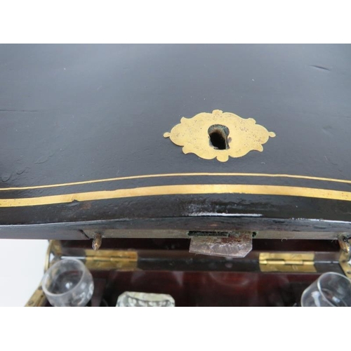 167 - A 19th century brass, inlaid ebonised decanter box, the hinged lid and side panels opening to reveal... 