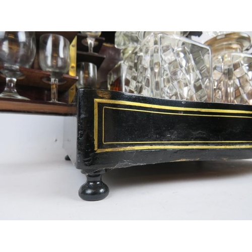 167 - A 19th century brass, inlaid ebonised decanter box, the hinged lid and side panels opening to reveal... 