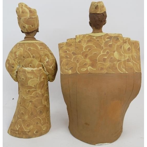 175 - Reuben Ugbine (Nigerian, b.1956) - a pair of stoneware figures, male and female in traditional Niger... 